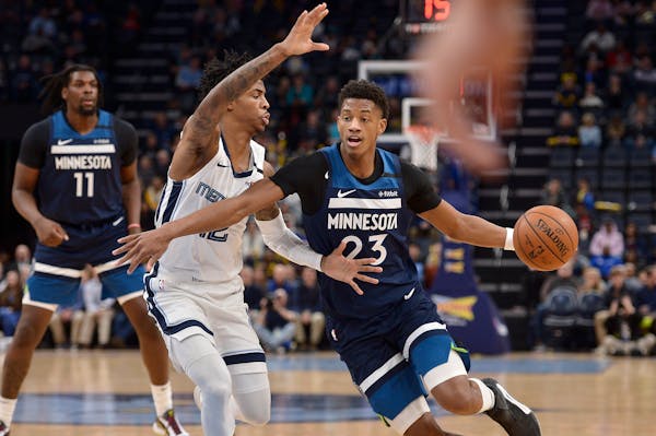Timberwolves guard Jarrett Culver drives against Memphis guard Ja Morant during the first half of a game Tuesday