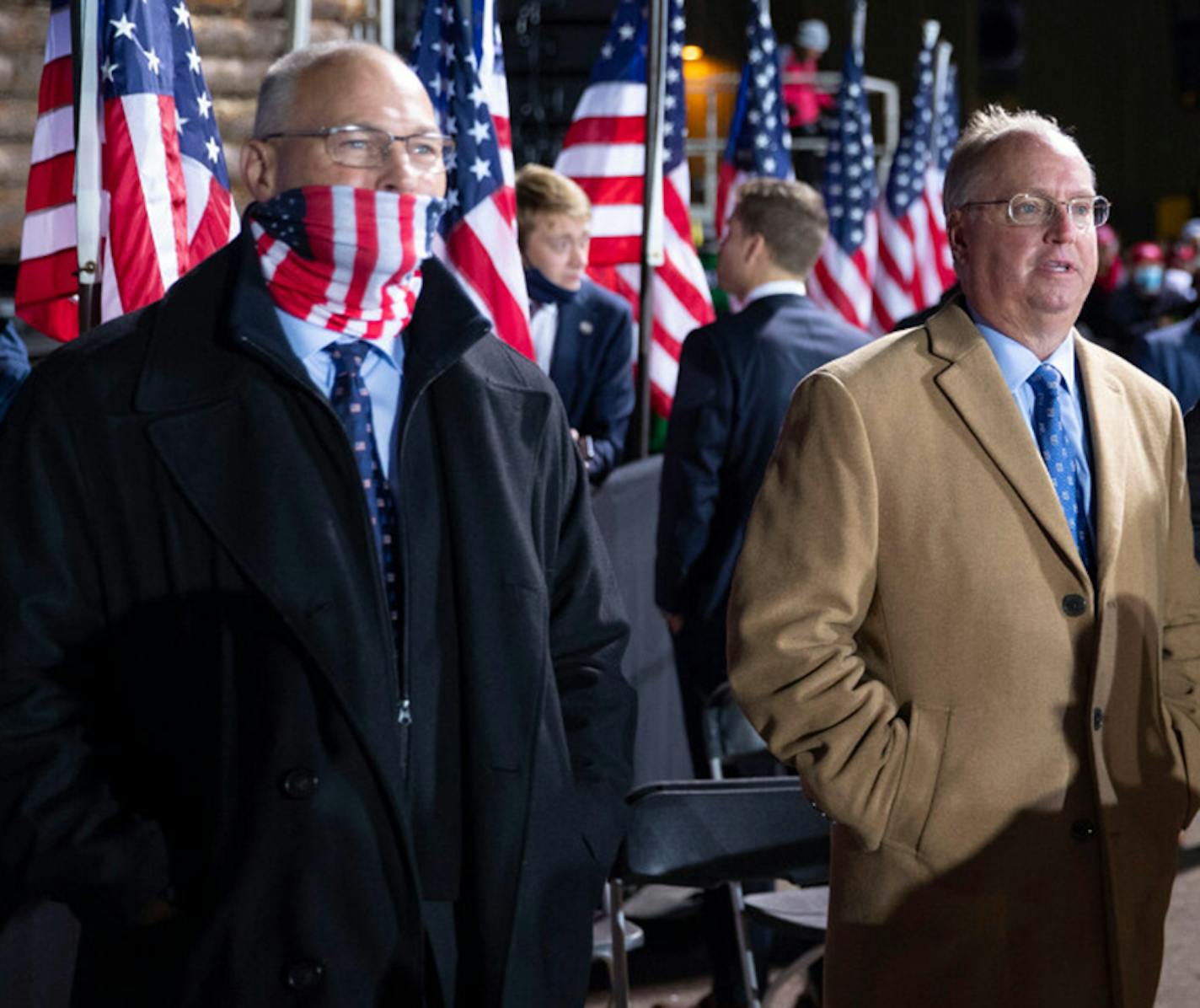 U.S. Reps Pete Stauber, left, and Jim Hagedorn stood off stage left during President Trump's remarks at Duluth International Airport on Wednesday night. The president tested positive for COVID-19 just over 24 hours later.