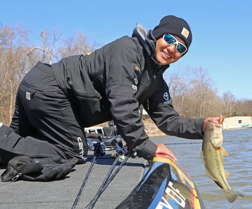 Trevor Lo of St. Paul with a dandy largemouth bass caught while practice fishing for the Bassmaster Classic on Grand Lake, Okla.