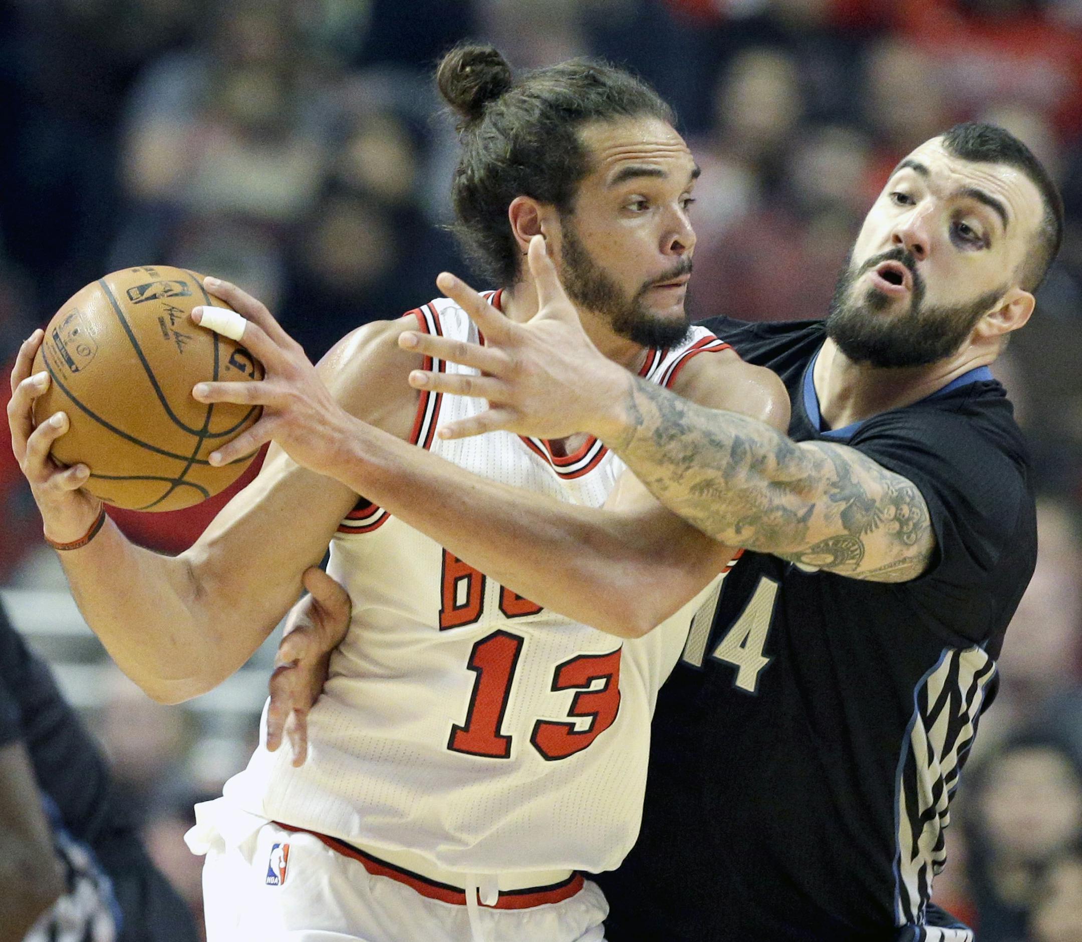Chicago Bulls center Joakim Noah (13) looks to a pass as Minnesota Timberwolves center Nikola Pekovic (14) guards during the first half of an NBA basketball game in Chicago on Friday, Feb. 27, 2015. (AP Photo/Nam Y. Huh)