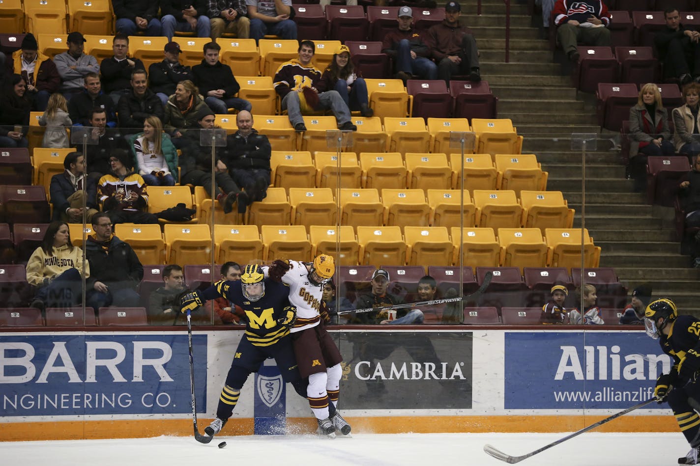 Wolverines defenseman Michael Downing (5) and Gophers forward Jack Ramsey (16) went for the puck as it spilled out of the Michigan zone in the third period. ] JEFF WHEELER &#xef; jeff.wheeler@startribune.com The University of Minnesota men's hockey team lost 6-2 to the University of Michigan Thursday night, February 25, 2016 at Mariucci Arena in Minneapolis.