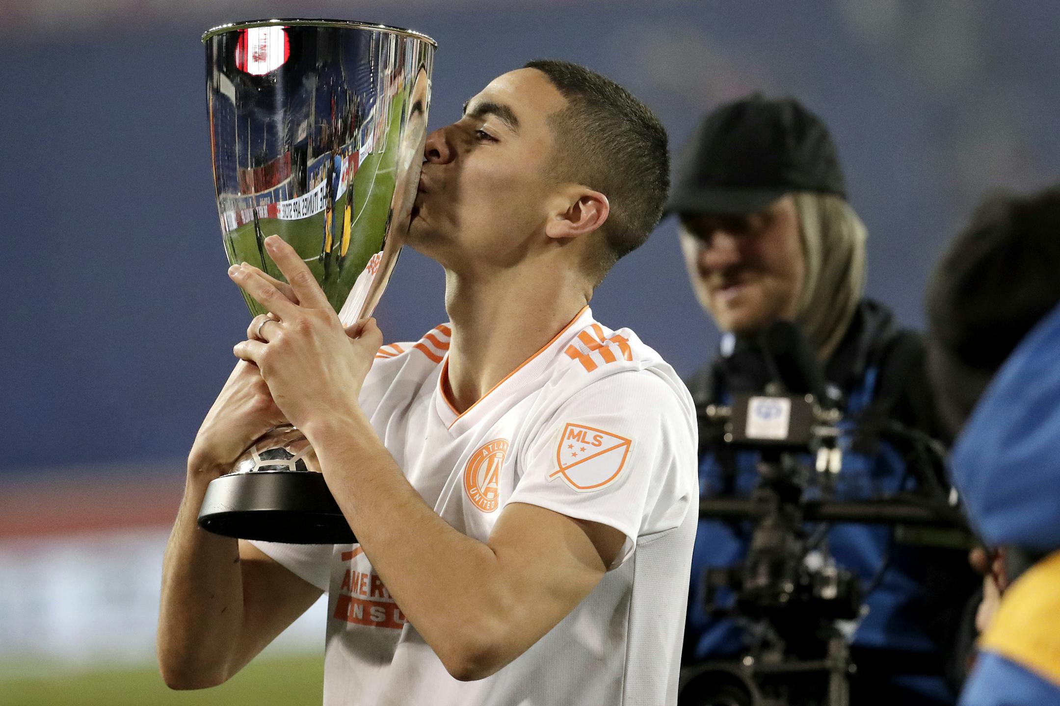 Atlanta United midfielder Miguel Almiron kisses the Eastern Conference trophy after the team won the MLS soccer Eastern Conference championship on, Nov. 29.