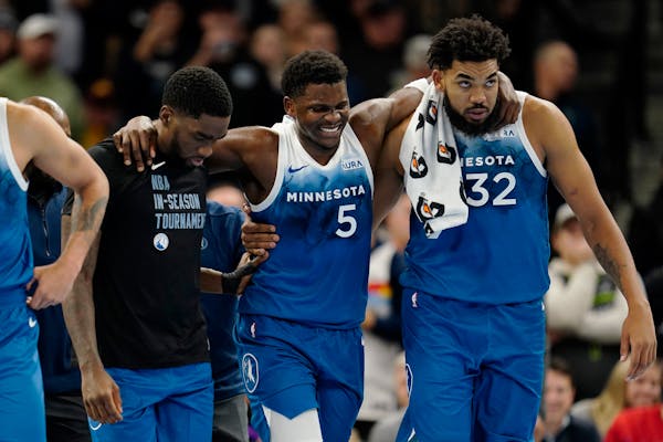 Timberwolves guard Anthony Edwards (5) was helped off the court after taking a fall on his right hip in the third quarter of Tuesday’s win against t