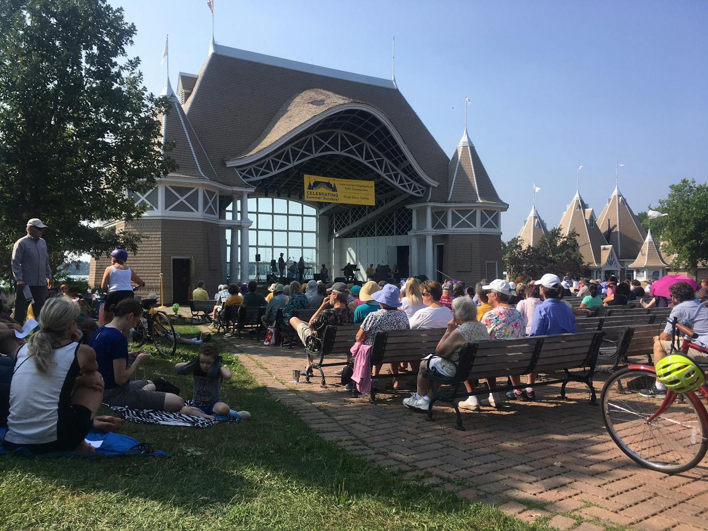 About 400 people gathered recently for a service held by First Universalist Church of Minneapolis, one of 15 faith communities sharing the stage at the Lake Harriet Bandshell this summer.