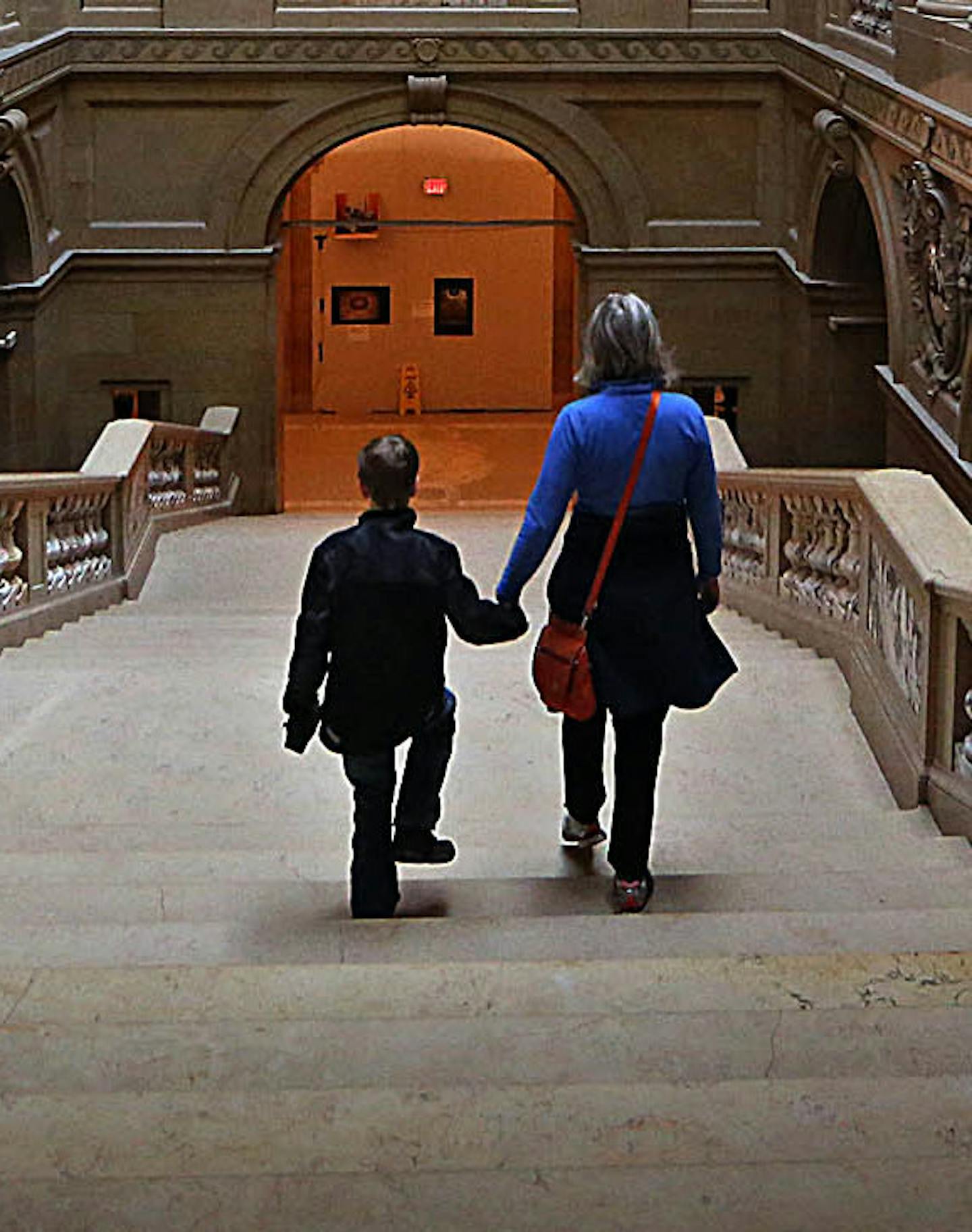 Anna Gambucci walked down a flight of steps with her son, Nathan, 9, St. Paul, after the pair had participated in a rally organized by Education Minnesota to protest the House education bill. Gambucci, a substitute teacher in the Roseville school district, said, &#xec;I came to support funding for all of the kids.&#xee; ] JIM GEHRZ &#xef; james.gehrz@startribune.com / St. Paul, MN / April 25, 2015 /10:45 AM - BACKGROUND INFORMATION: The House will take up its omnibus education bill, which propos