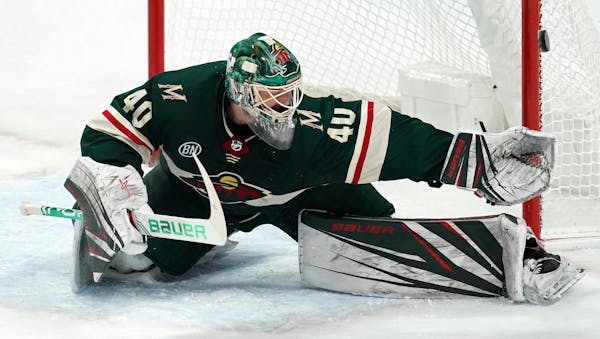 Minnesota Wild goaltender Devan Dubnyk (40) stretches out to make a save in the second period against the Calgary Flames on Saturday, Dec. 15, 2018, a