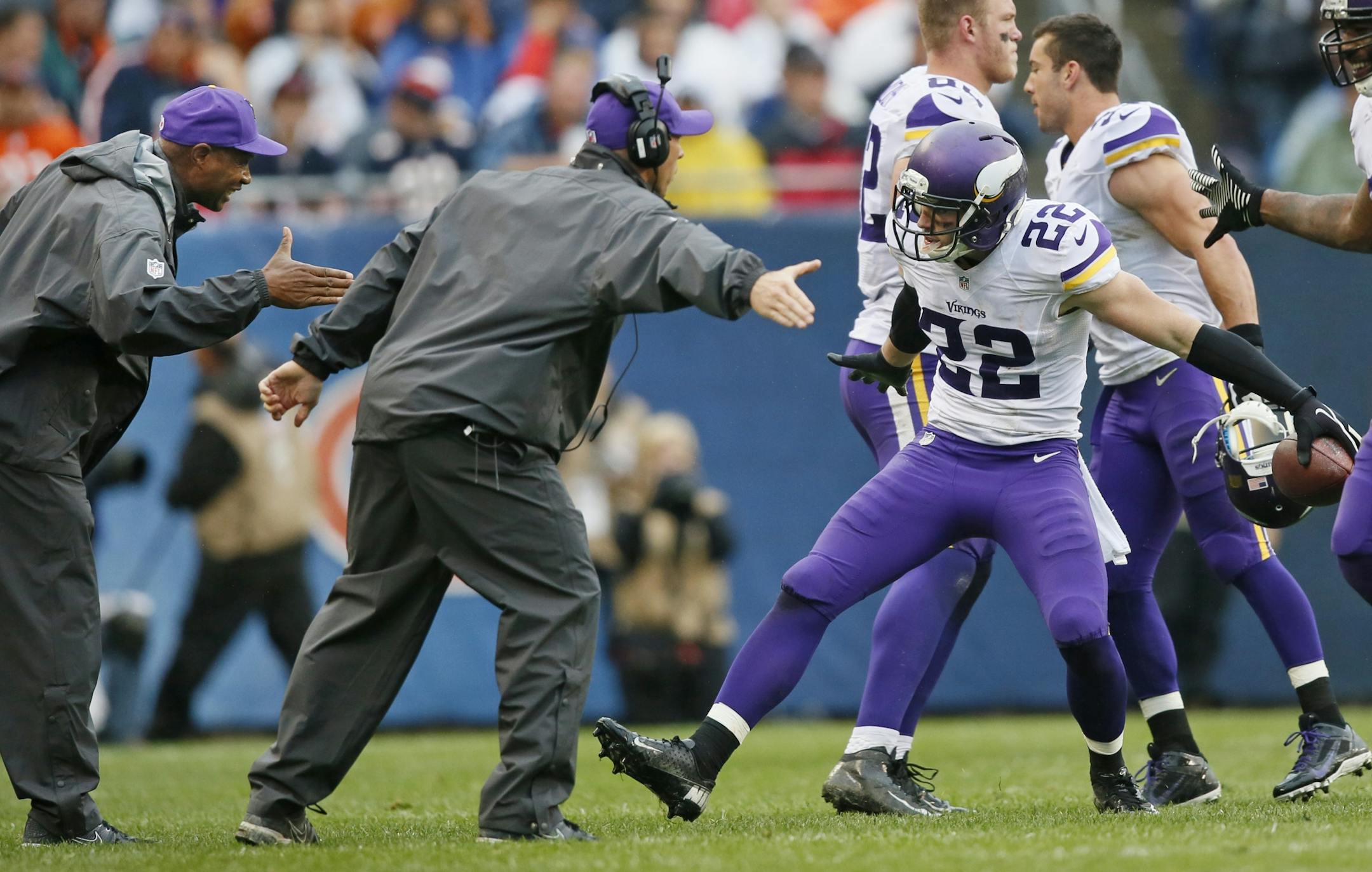 Harrison Smith (22) celebrated an interception with coach Leslie Frazier and defensive line coach Jeff Davidson. Smith has been sidelined since October with turf toe.