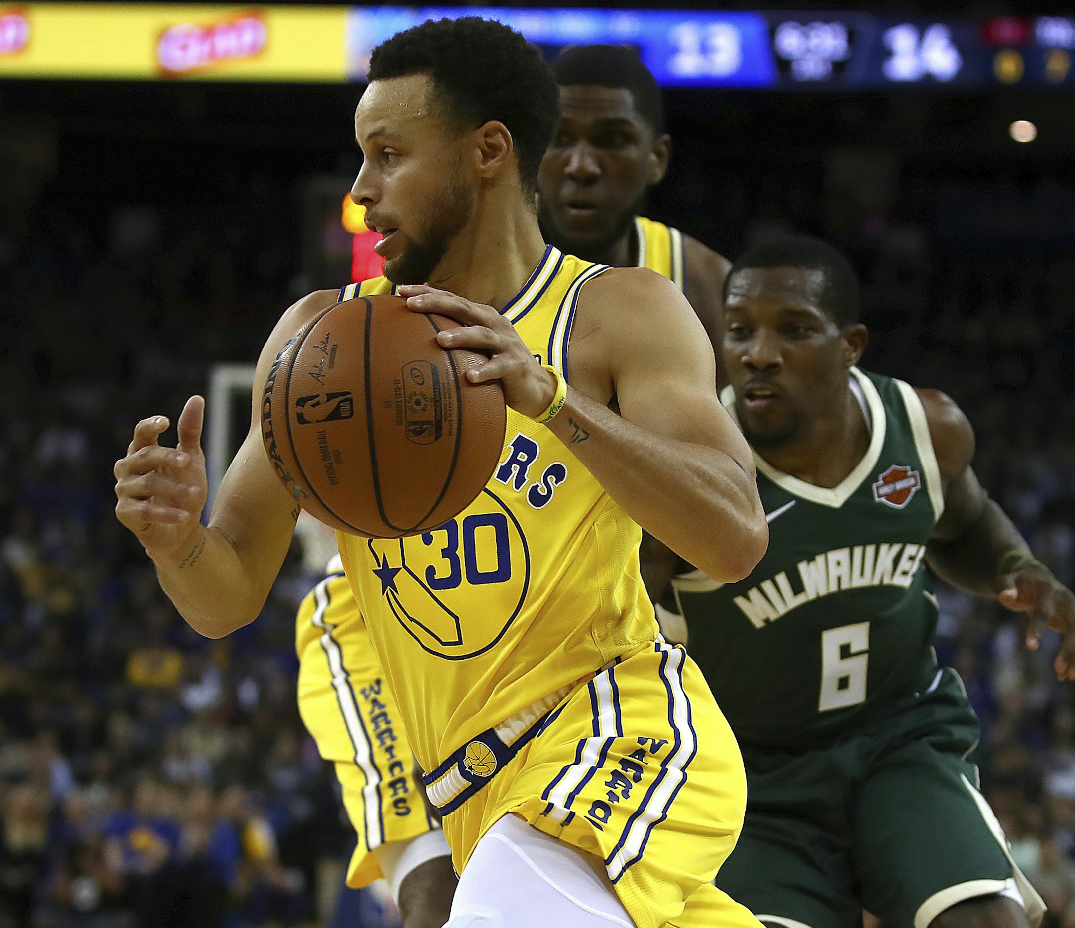 Golden State Warriors' Stephen Curry drives the ball past Milwaukee Bucks' Eric Bledsoe (6) during the first half of an NBA basketball game Thursday, Nov. 8, 2018, in Oakland, Calif. (AP Photo/Ben Margot)