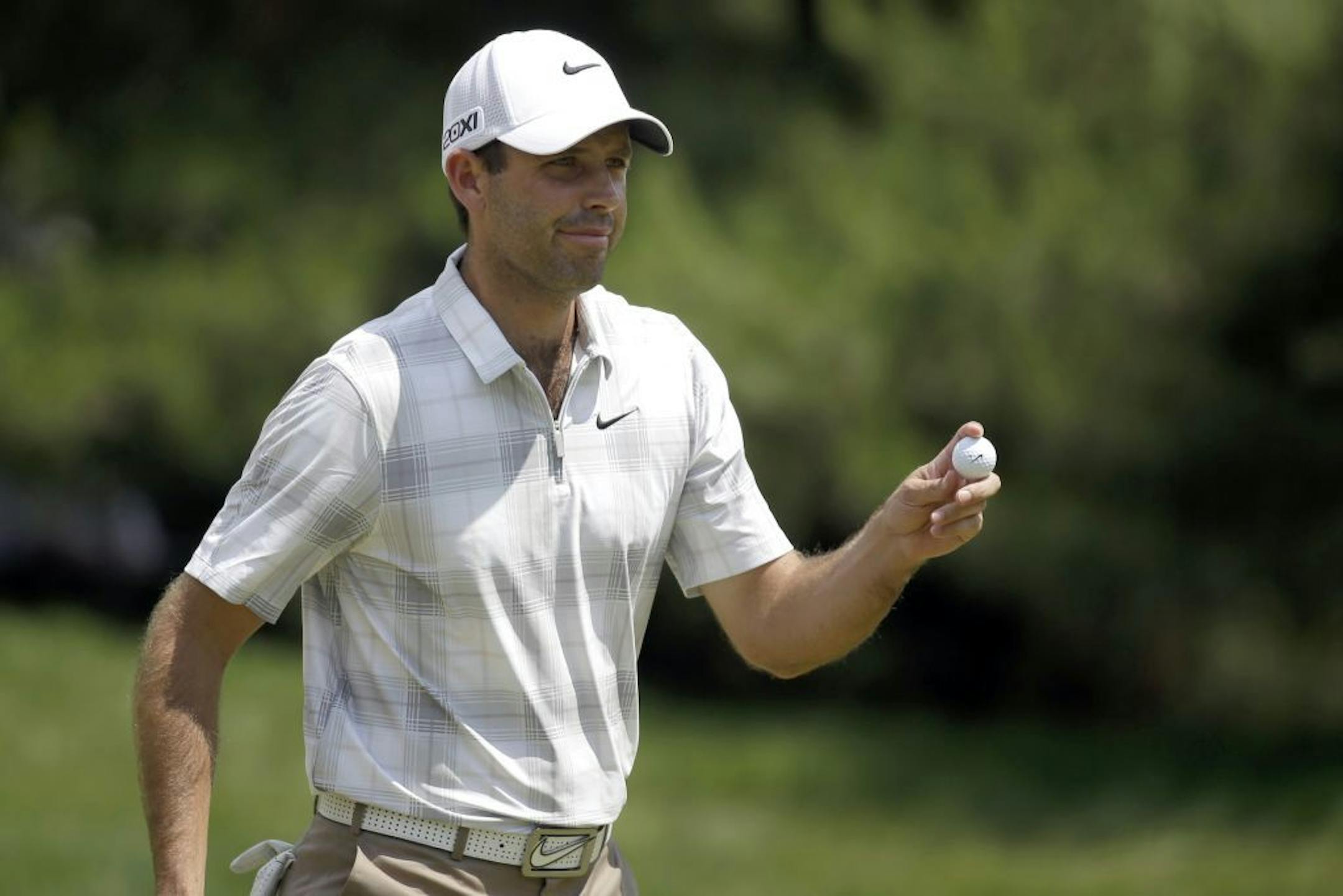 Charl Schwartzel, of South Africa, reacts after putting on the first hole during the third round of the U.S. Open golf tournament at Merion Golf Club, Saturday, June 15, 2013, in Ardmore, Pa.