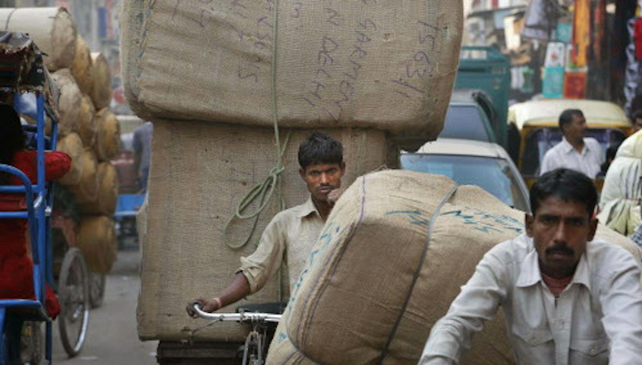 An Indian walks with his cart filled with goods at a wholesale market in New Delhi, India, Tuesday, Oct. 29, 2013. India's September wholesale inflation rose to 6.5 percent, well over the central bank's target of 4.0-4.5 percent. Consumer price inflation, which factors in volatile food prices and hits hundreds of millions of poor Indians hardest, was even higher at 9.8 percent in September. (AP Photo /Manish Swarup)