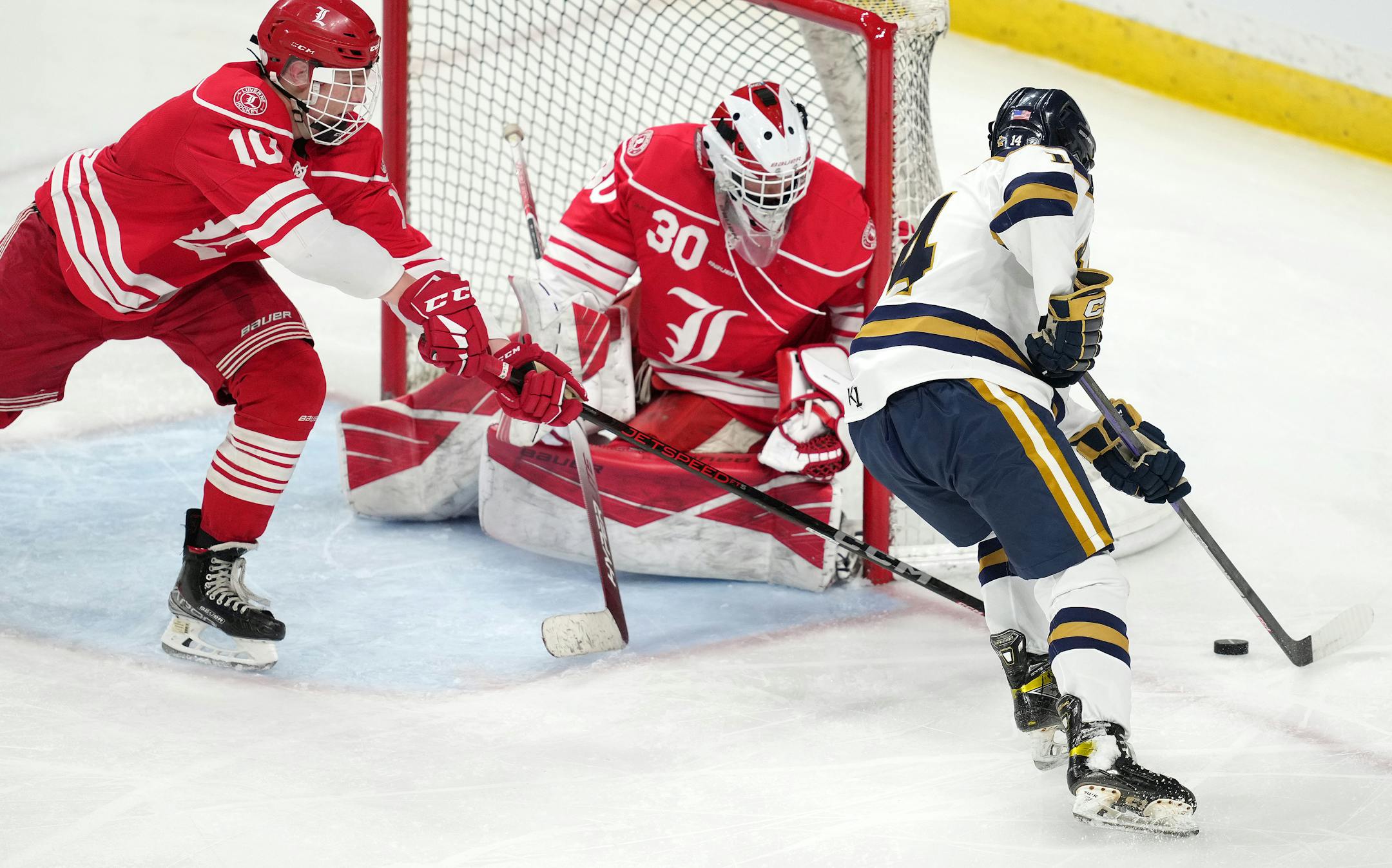 Hermantown forward Aaron Evjen (14) takes the puck around Luverne goaltender Tyler Arends (30) in the second period of a MSHSL Class 1A quarterfinal hockey game between Luverne and Hermantown.
