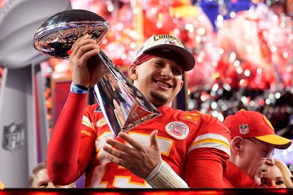 Kansas City Chiefs quarterback Patrick Mahomes celebrates with the trophy after the team's win in overtime during the NFL Super Bowl 58 football game 