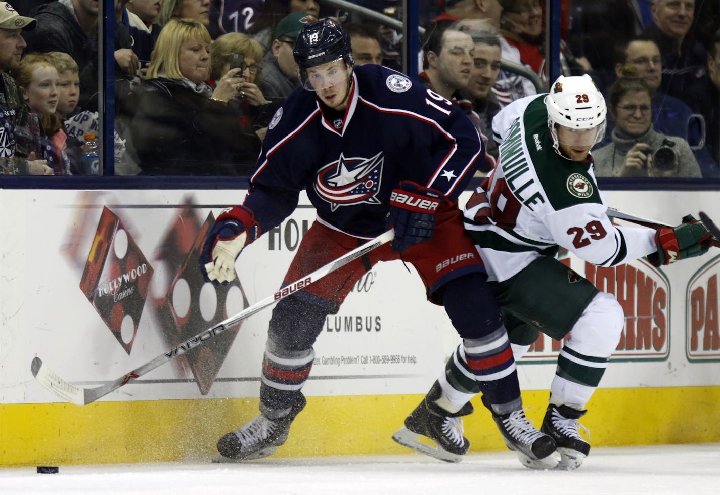 Columbus Blue Jackets' Ryan Johansen, left, works for the puck against Minnesota Wild's Jason Pominville during an NHL hockey game in Columbus, Ohio, Tuesday, Jan.5, 2016. Minnesota won 4-2. (AP Photo/Paul Vernon) ORG XMIT: ohpvotk20