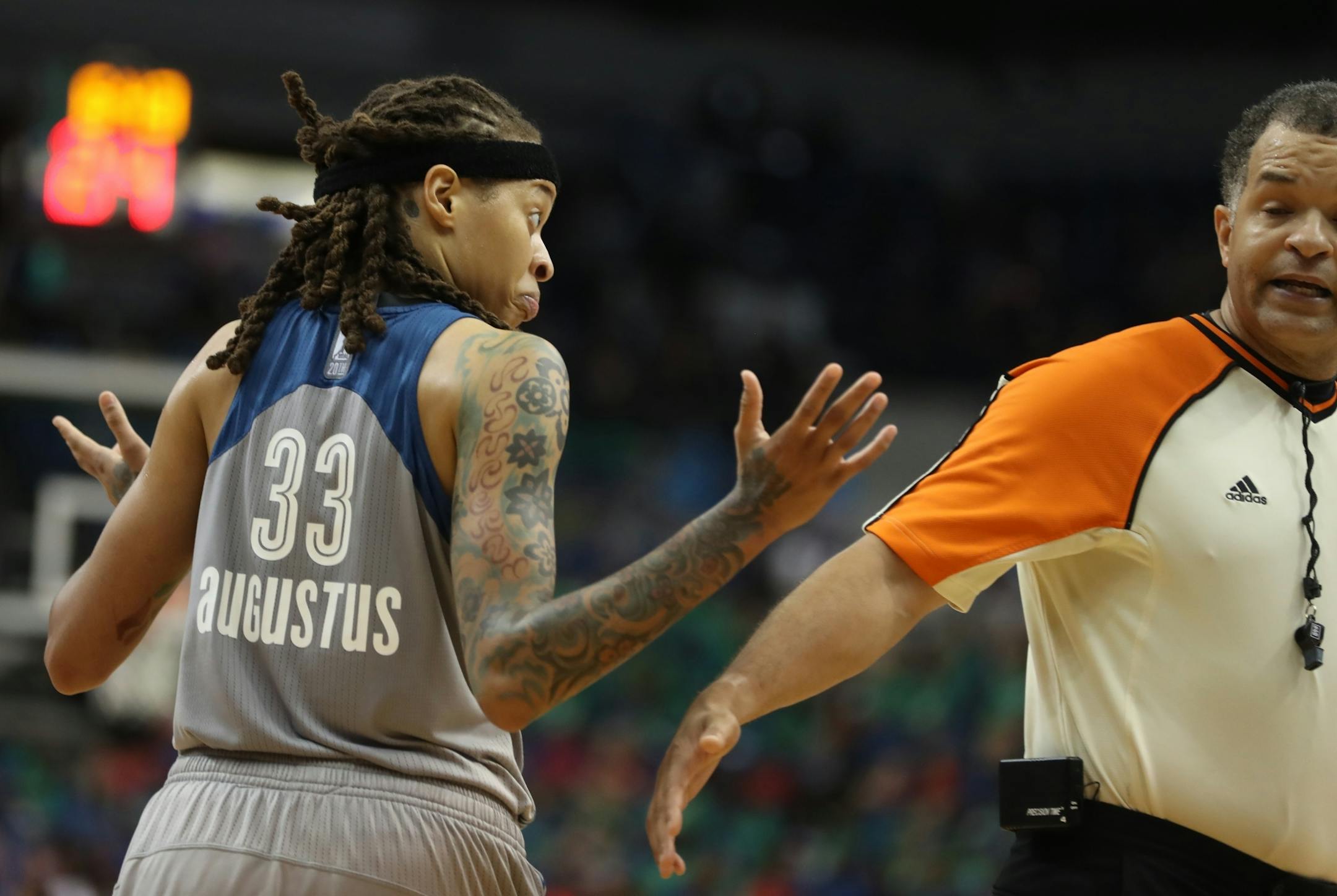 Seimone Augustus(33) tries to avoid a technical against Dream player Matee Ajavon(10).