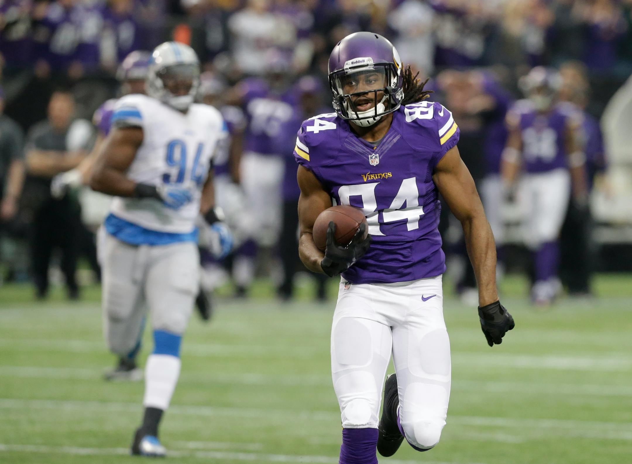 Minnesota Vikings wide receiver Cordarrelle Patterson, right, runs up field during a 50-yard touchdown run in the first half of an NFL football game against the Detroit Lions, Sunday, Dec. 29, 2013, in Minneapolis. (AP Photo/Jim Mone)