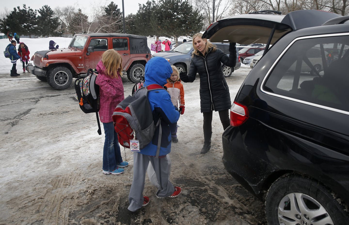 At Ridgeview Elementary School in Bloomington, Loran Meccia served as chauffeur to the the Kinney girls Fiona, Ciara, Vivian, a 5th, 3rd, and 1st grader respectively . The girls attend the Bloomington school district because they have a full time gifted and talented program that starts in second grade.]richard tsong-taatarii/rtsong-taatarii@startribune.com