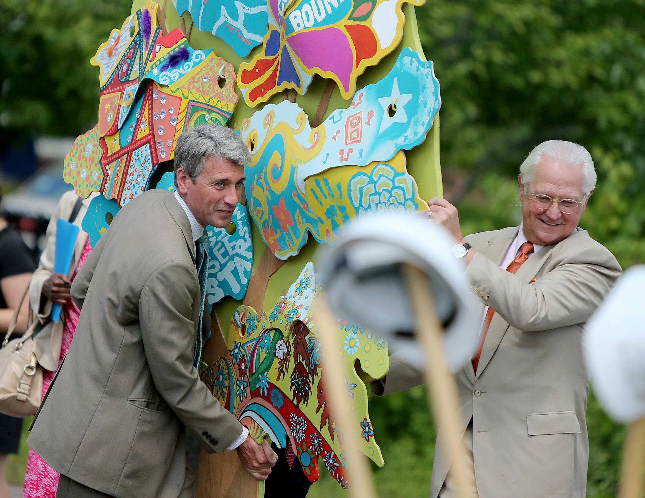 Minneapolis Mayor R.T. Rybak, left, and former anchor Don Shelby carried a tree to the groundbreaking ceremony of what will be a new $24.5 million Washburn Center for Children, Tuesday, August 13, 2013. The center will be a children's mental health center in North Minneapolis. Washburn Center for Children is a resource center that helped children experiencing social, emotional, and behavioral changes. The center serves more than 10,000 community members annually.(ELIZABETH FLORES/STAR TRIBUNE) E