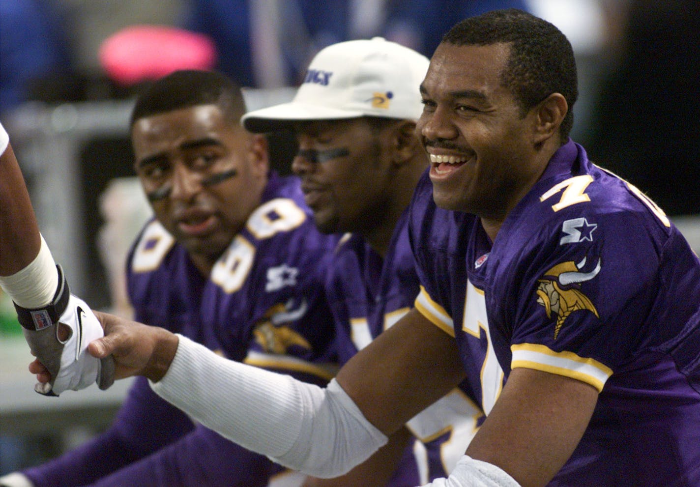 Vikings v. Jacksonville Jaguars -- A happy Randall Cunningham receives a congratulatory handshake during the third quarter following his touchdown throw to Randy Moss, center. At left is Cris Carter.