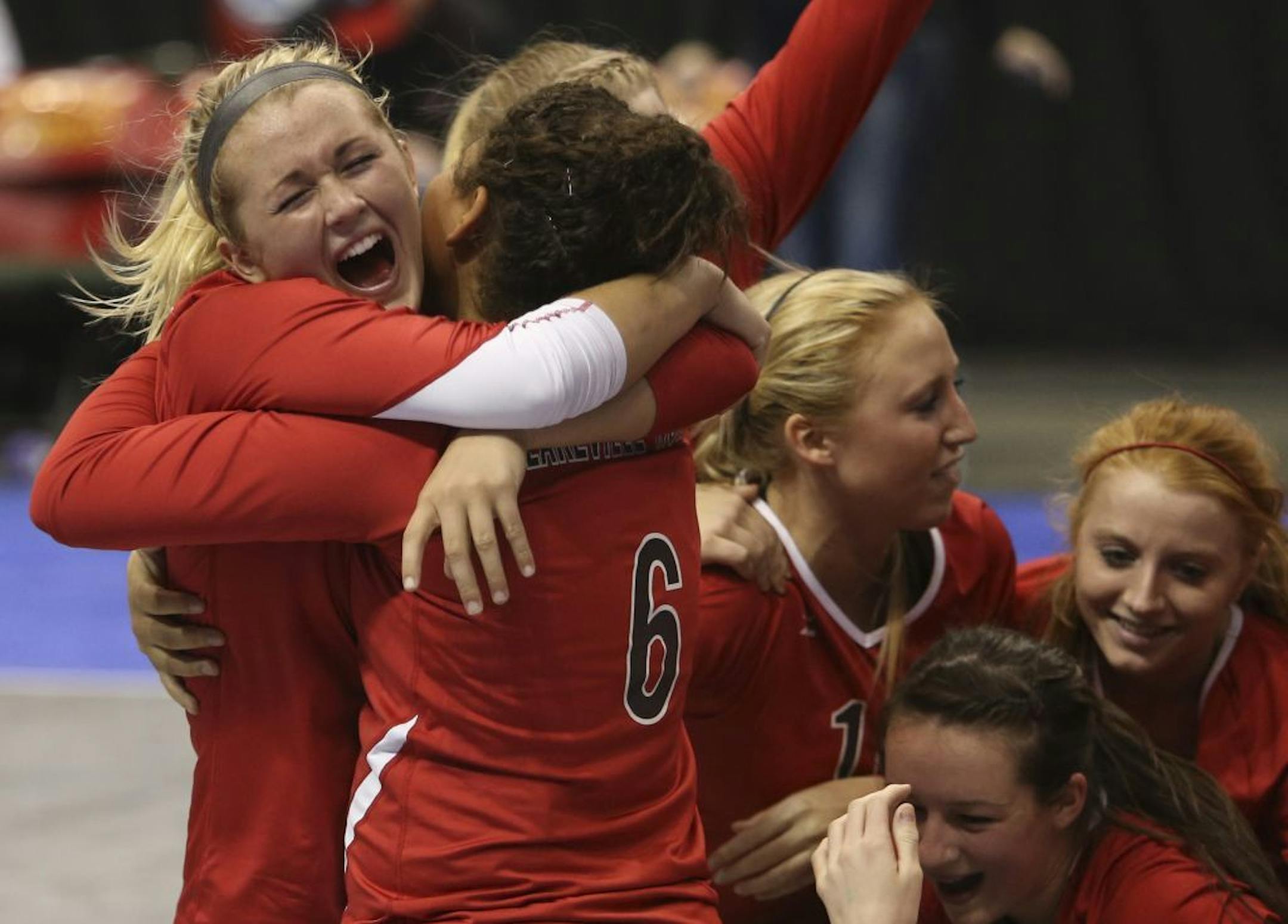 Lakeville North's Alyssa Goehner and Abby Monson hugged after winning in the Class 3A volleyball finals in 2012