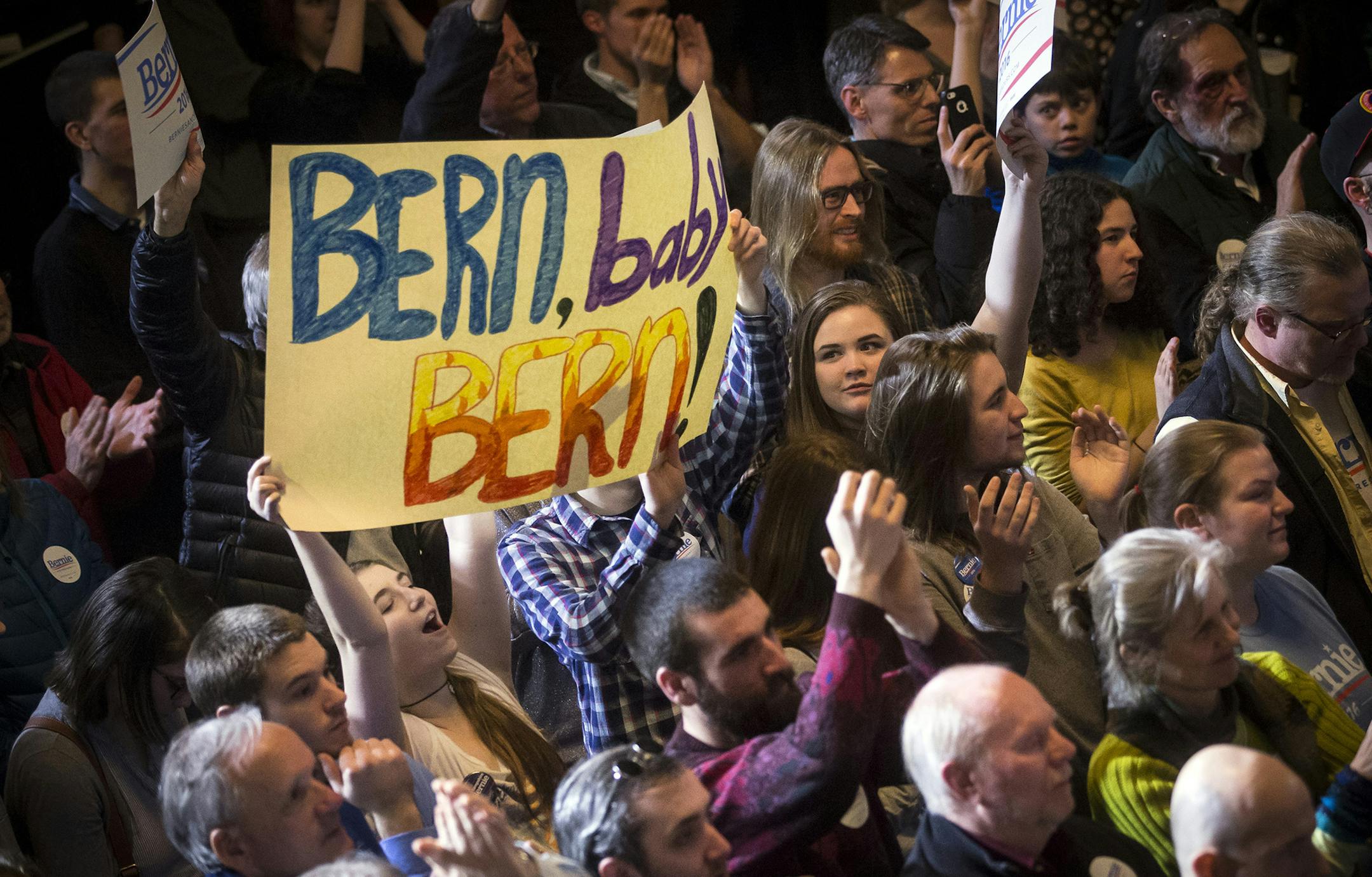 A young woman cheers while holding a sign as Democratic presidential candidate Sen. Bernie Sanders, I-Vt., speaks during a campaign stop at the Rochester Opera House, Thursday, Feb. 4, 2016, in Rochester, N.H. (AP Photo/John Minchillo) ORG XMIT: MIN2016021912421859