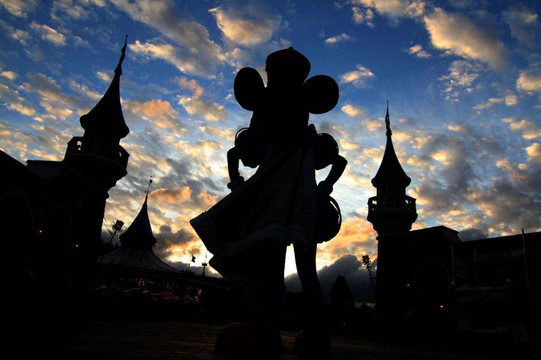 Mickey Mouse watches the sun set at the New Fantasyland at Walt Disney World's Magic Kingdom in Lake Buena Vista, Florida.