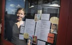 Workhorse Coffee Bar owner Shannon Forney is reflected in the glass of the Smallest Museum in St. Paul.
