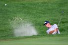Michael Thompson hits out of a bunker on the 12th hole during the final round of the 3M Open golf tournament in Blaine, Minn., Sunday, July 26, 2020. 