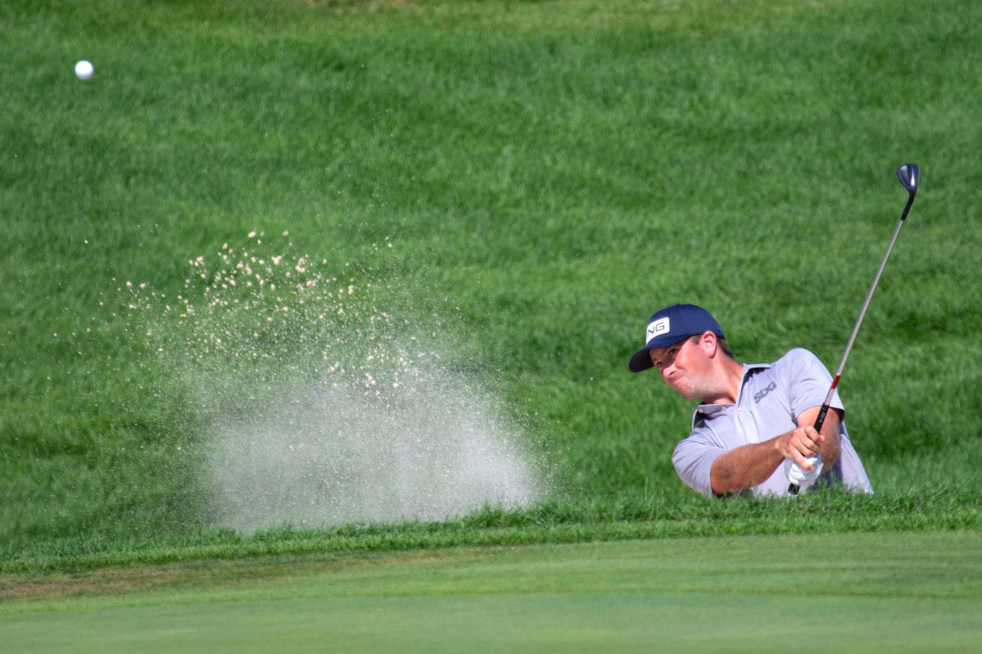 Michael Thompson hits out of a bunker on the 12th hole during the final round of the 3M Open golf tournament in Blaine, Minn., Sunday, July 26, 2020. (AP Photo/Andy Clayton-King)