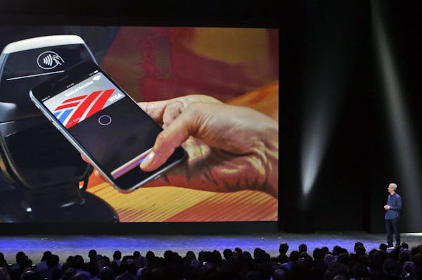 Apple CEO Tim Cook introduces the new Apple Pay product on Tuesday, Sept. 9, 2014, in Cupertino, Calif. (AP Photo/Marcio Jose Sanchez)