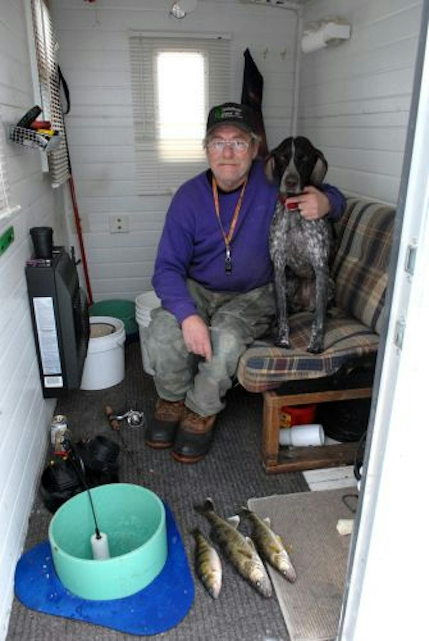 Roger Kramer of Eagan and his shorthaired pointer, Sadie, with two walleyes and a perch caught Saturday afternoon on Mille Lacs.