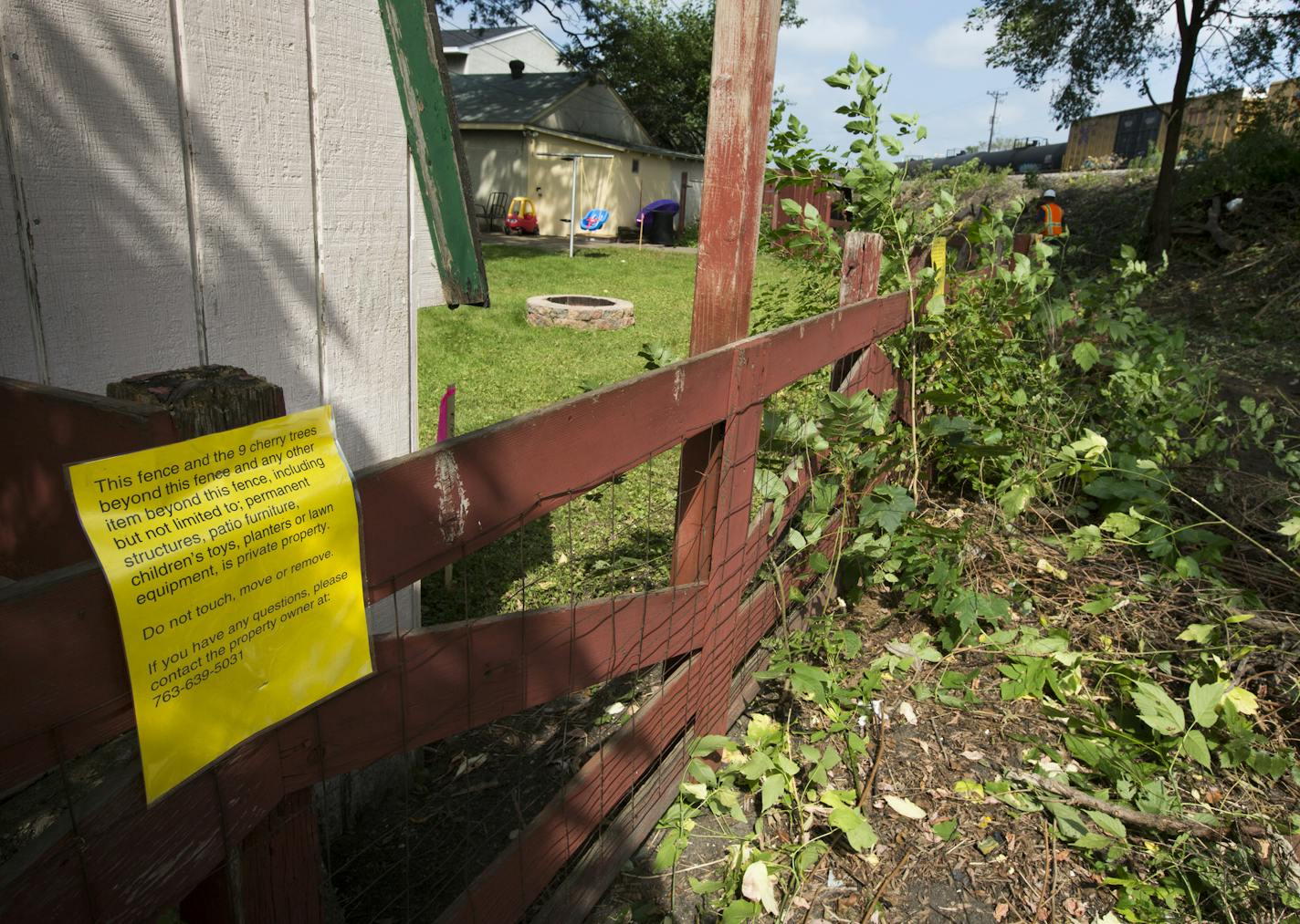 A resident in the 2300 block of 7th St. N.E. posted a sign on their fence disputing the property line posted by the railroad. ] BNSF's plans to expand their railroad capacity is bringing tracks about 14 feet closer to people's homes along a tight corridor in Northeast Minneapolis. Homeowners are upset, in part because BNSF says they actually own the land that contains the yards and garages of private homes. Workers are already tearing down trees that sheilded homeowners from the 95 trains that p