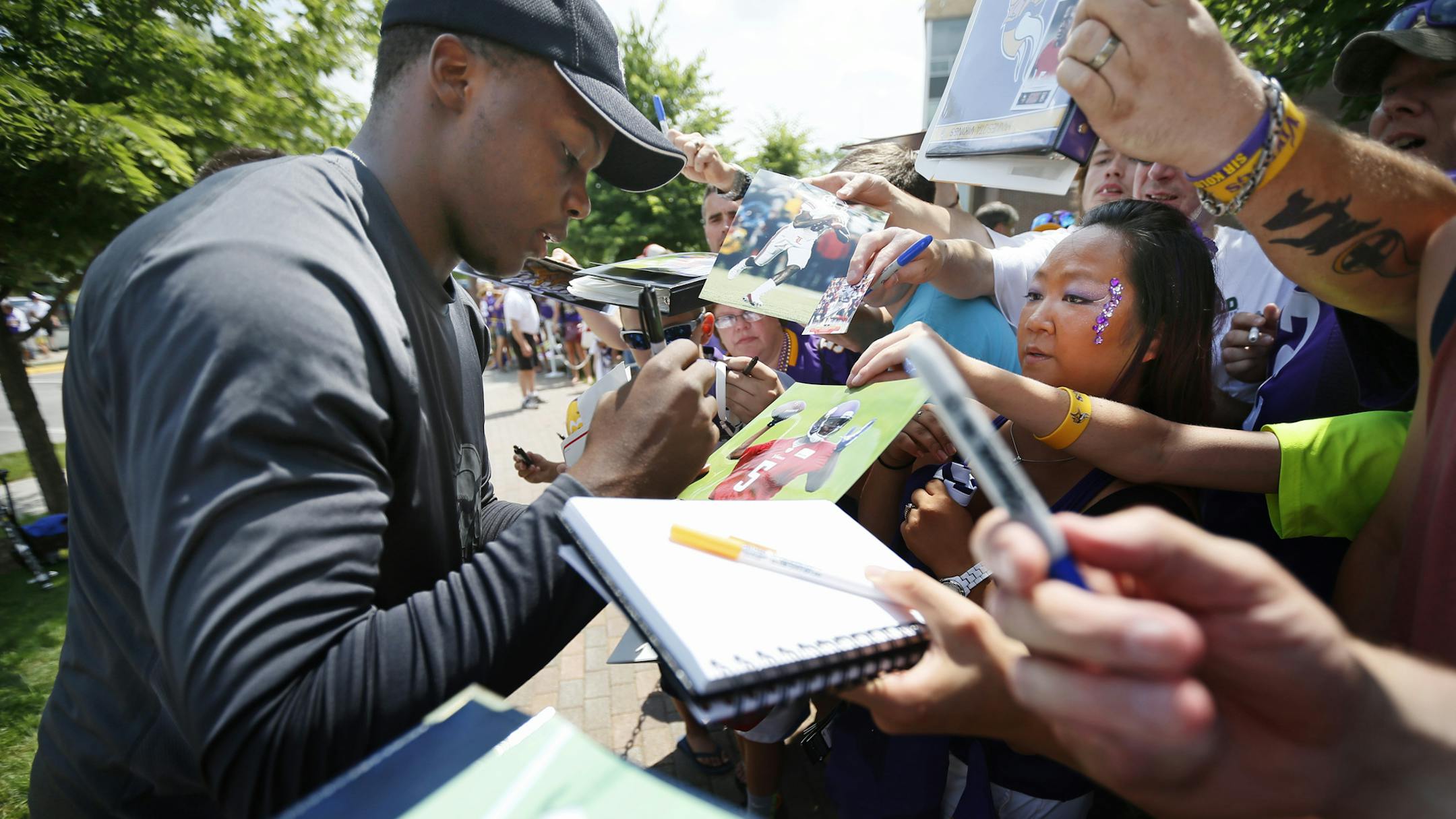 Vikings rookie quarterback Teddy Bridgewater singed a autograph for Erin Darsow as the players reported for camp at the University of Minnesota Mankato Thursday July 24, 2014 . ] Jerry Holt Jerry.holt@startribune.com