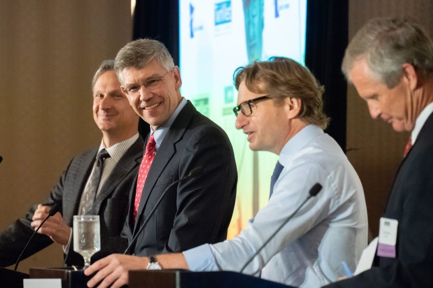 Rep. Erik Paulsen and DFL challenger Dean Phillips squared off Tuesday in their first debate ahead of the November election. They are flanked by WCCO's Chad Hartman and KSTP's Tom Hauser. and greeted each other at the end of Tuesday's fifth district debate.