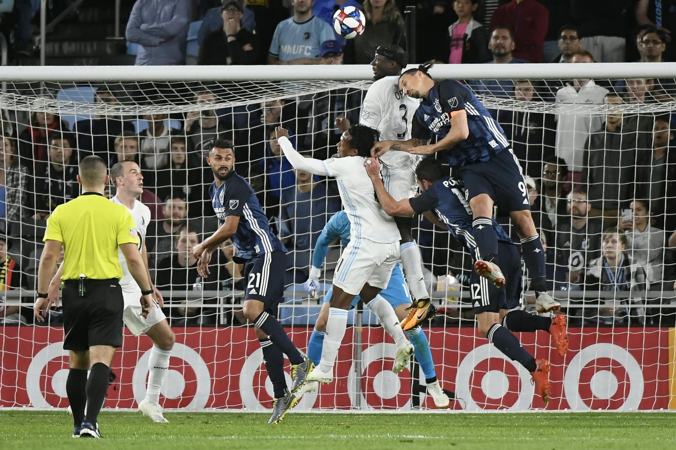 Los Angeles Galaxy forward Zlatan Ibrahimovic (9) and forward Chris Pontius (12) jumped for a header against Minnesota United forward Romario Ibarra (11) and defender Ike Opara (3) during a Galaxy corner kick late in the second half Wednesday.