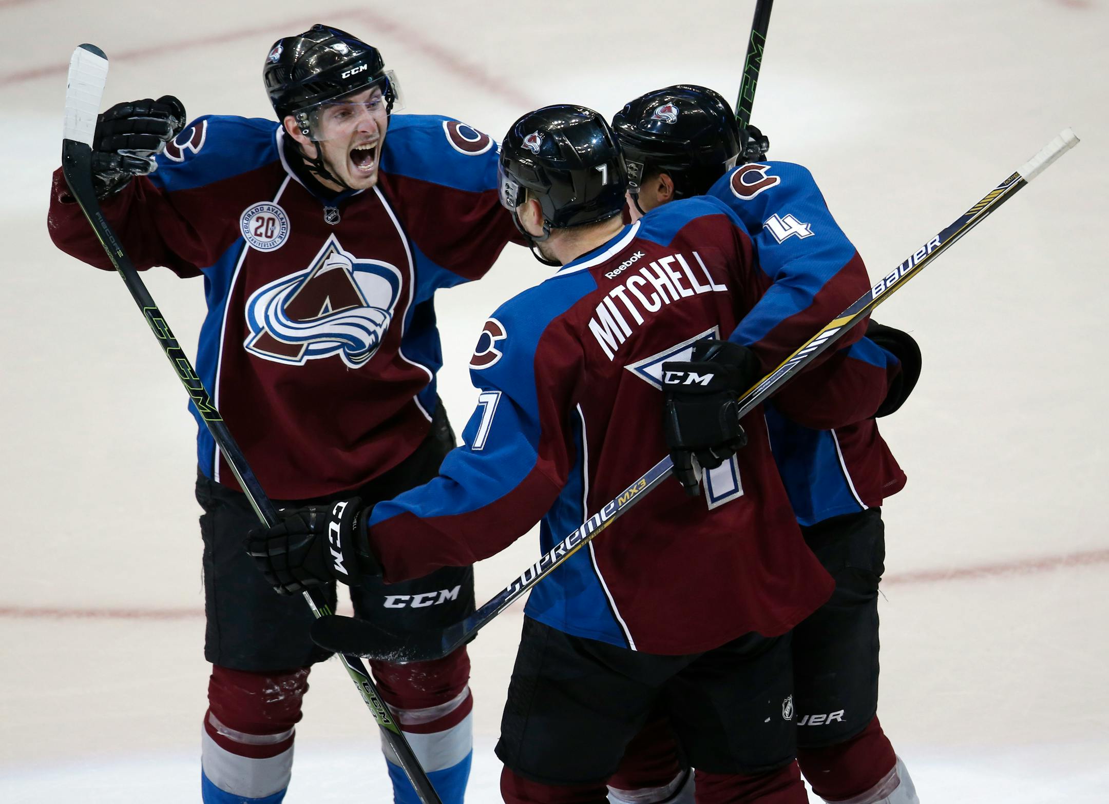 Avalanche center Matt Duchene, left, celebrated with center John Mitchell, center, and defenseman Tyson Barrie after Mitchell's game-winning goal against the Wild in overtime Monday.