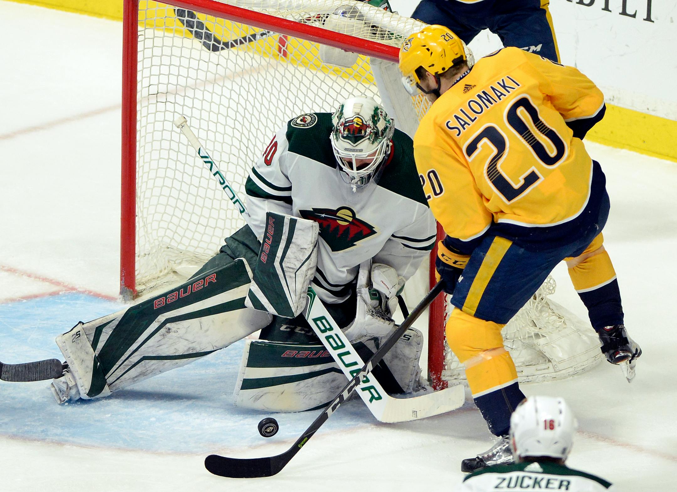 Minnesota Wild goaltender Devan Dubnyk (40) blocks a shot by Nashville Predators right wing Miikka Salomaki (20), of Finland, during the first period of an NHL hockey game Tuesday, March 27, 2018, in Nashville, Tenn. (AP Photo/Mark Zaleski)