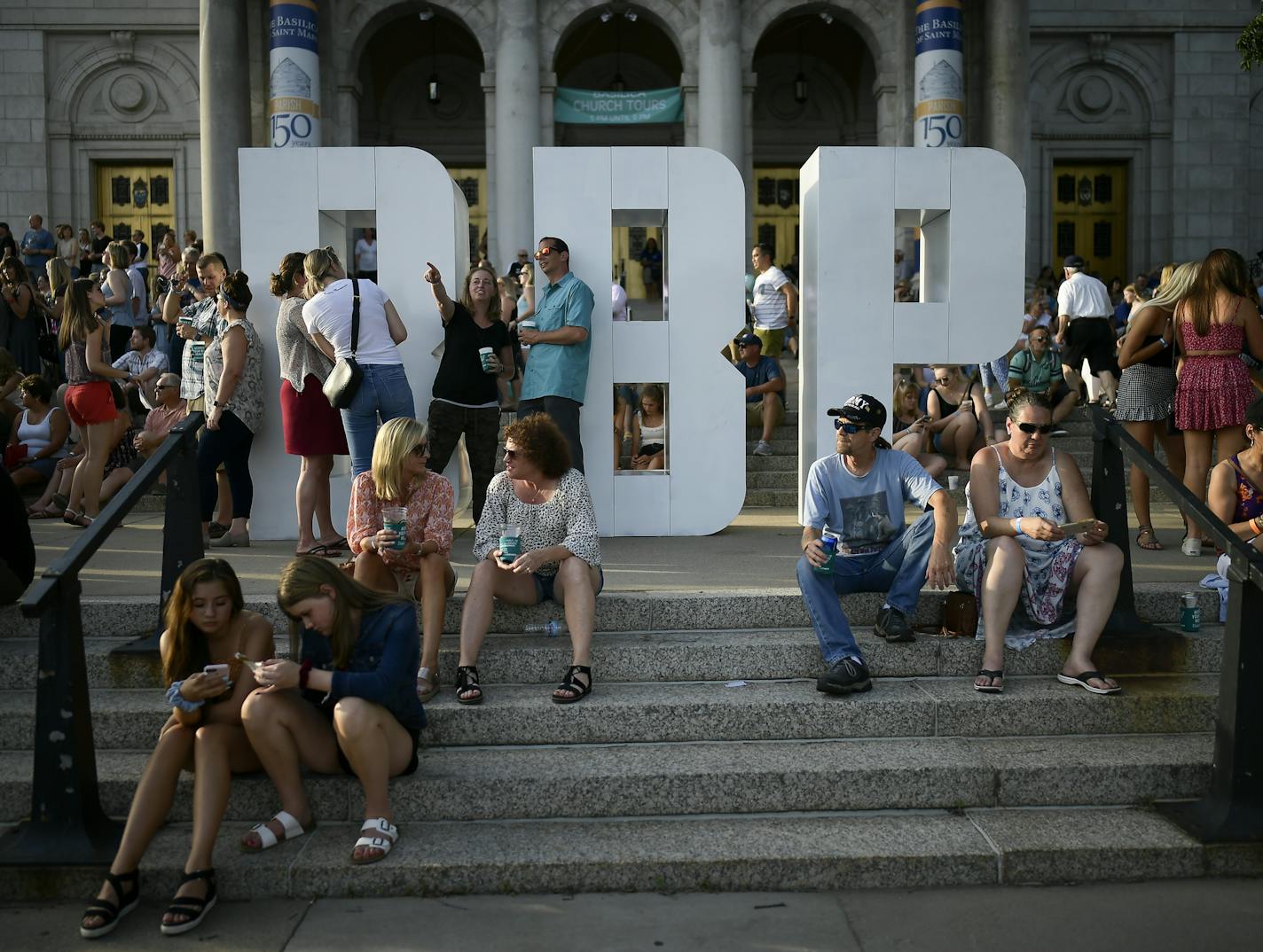 Block party goers sat near the giant "BBP" letters, the acronym of Basilica Block Party, in front of the Basilica Friday night as the Jayhawks performed Friday night. ] Aaron Lavinsky &#xa5; aaron.lavinsky@startribune.com The Basilica Block Party was held Friday, July 12, 2019 at the Basilica of St. Mary grounds in Minneapolis, Minn.