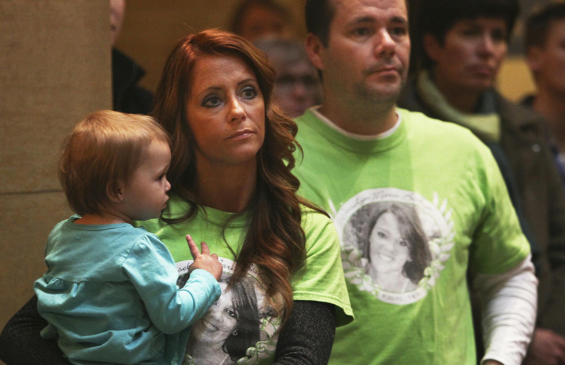 During the "Action Day" held by the Minnesota Coalition for Battered Women, Tonya Barthel held her daughter Ashlyn Watson, 1, as her boyfriend Jamie Erickson stood by during a rally at the Capitol Tuesday, March 12, 2013 in St. Paul, MN. Barthel and Erickson were wearing shirts honoring Josselyn Marie Bishop, a Mankato State University student who was killed by her ex-boyfriend. Bishop was best friends with Erickson's son.] (DAVID JOLES/STARTRIBUNE) djoles@startribune.com Capitol rallies: the Go