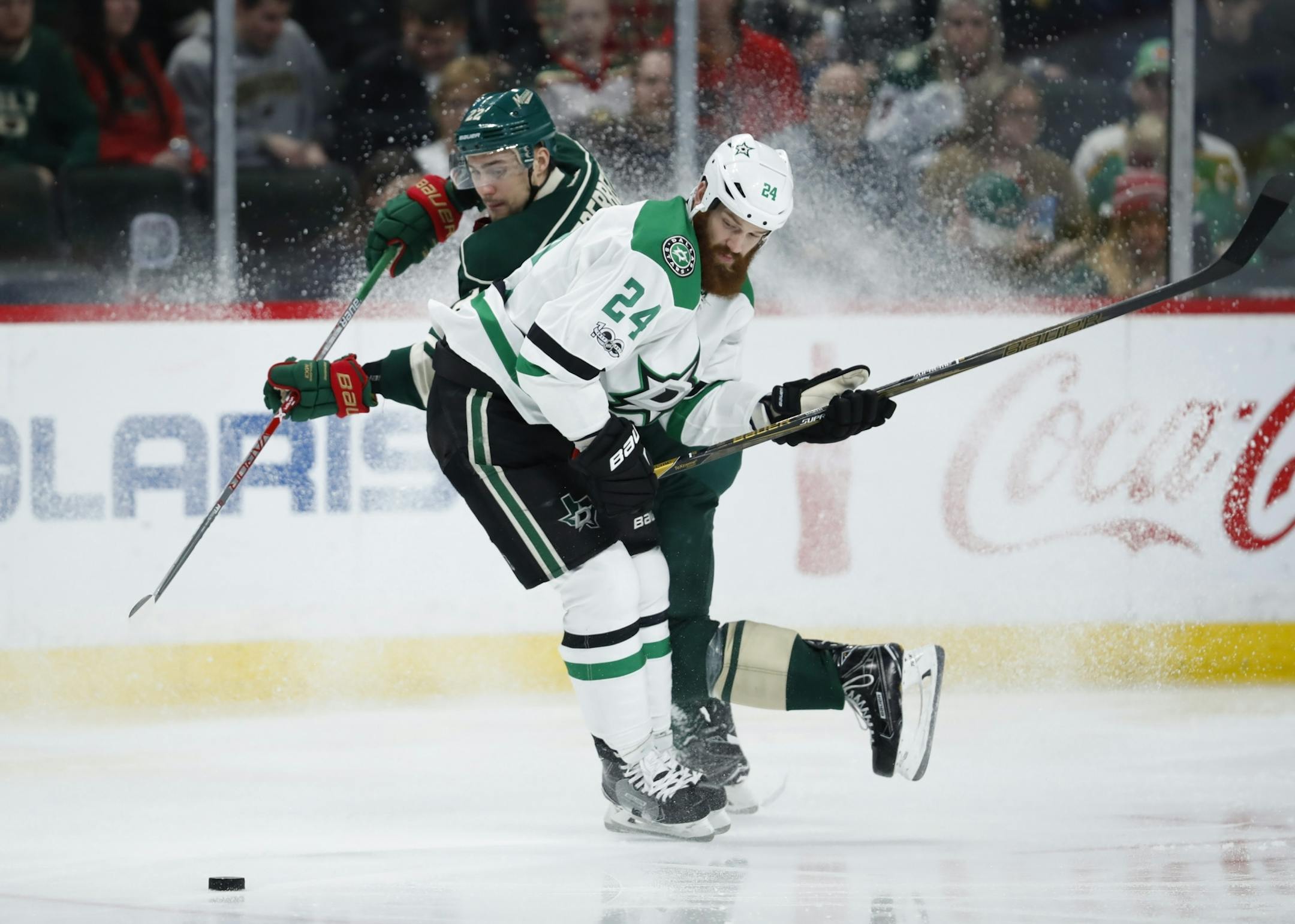 Dallas Stars defenseman Jordie Benn (24) checked Minnesota Wild right wing Nino Niederreiter (22) off the puck in the third period.