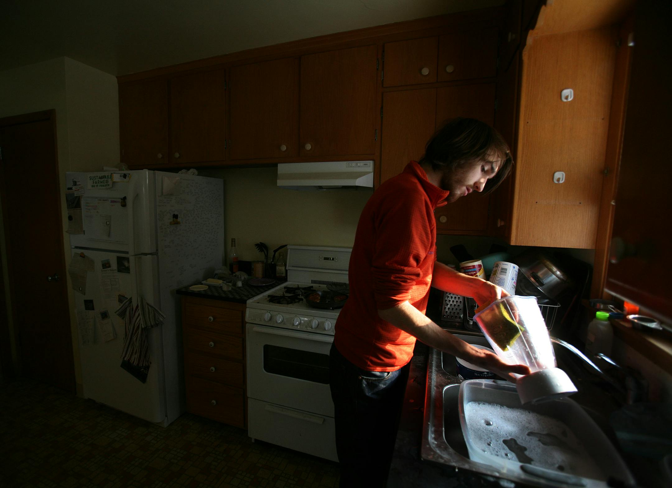 Avery Bowron, a 2nd-year student at Macalester College, washed dishes in a sink made of recycled pop cans.