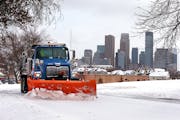 City of Minneapolis plow clears snow from a Olson Highway Service Road in Minneapolis.