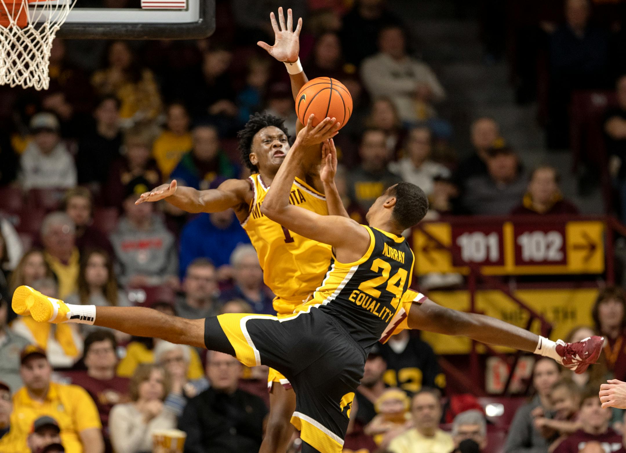 Joshua Ola Joseph (1) of the Minnesota Gophers defends Kris Murray (24) of the Iowa Hawkeyes in the first half.