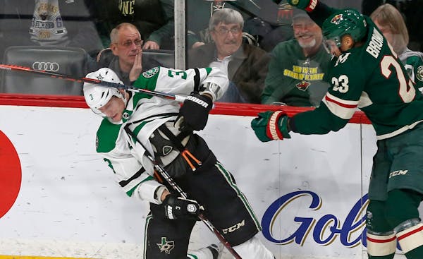 Minnesota Wild's Gustav Olofsson, right, of Sweden, loses his stick to Dallas Stars' John Klingberg, of Sweden, along the boards in the first period o