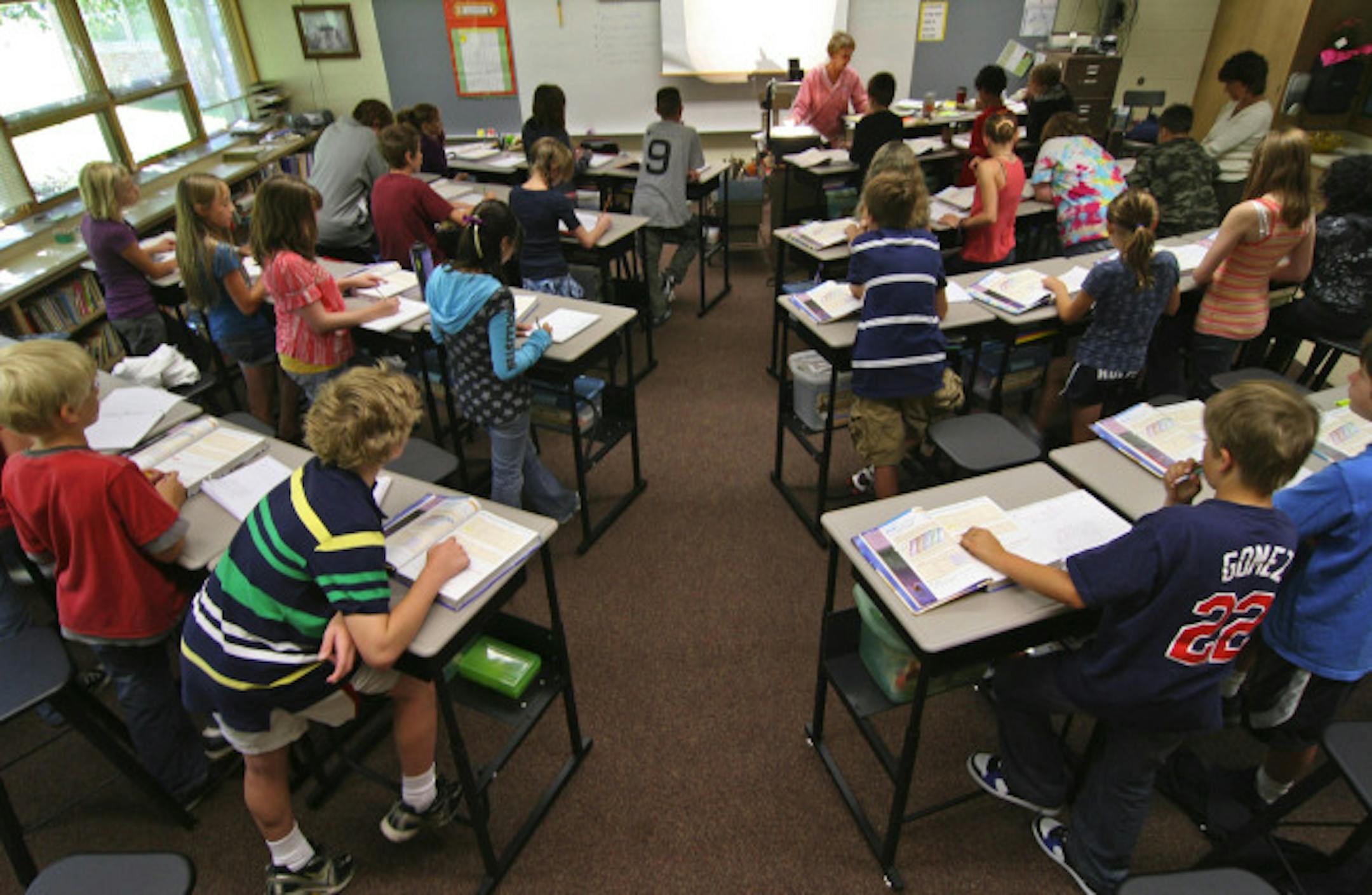The sixth grade math class taught by Abby Brown uses the standing desks she developed,- adjusted to accomondate different heights,- as do the other classes at Marine Elementary