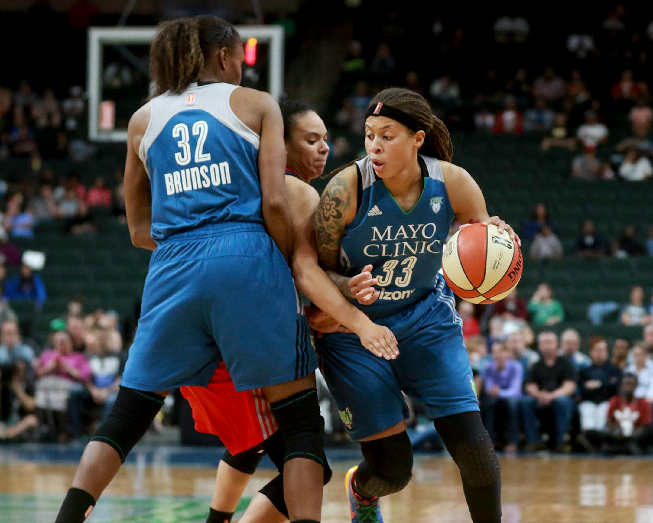 The Minnesota Lynx Rebekkah Brunson (32) sets a pick for Seimone Augustus (33) against he Washington Mystic's Kristin Toliver, center during the second quarter Friday, June 22, 2017, at the Xcel Energy Center in St. Paul, MN.