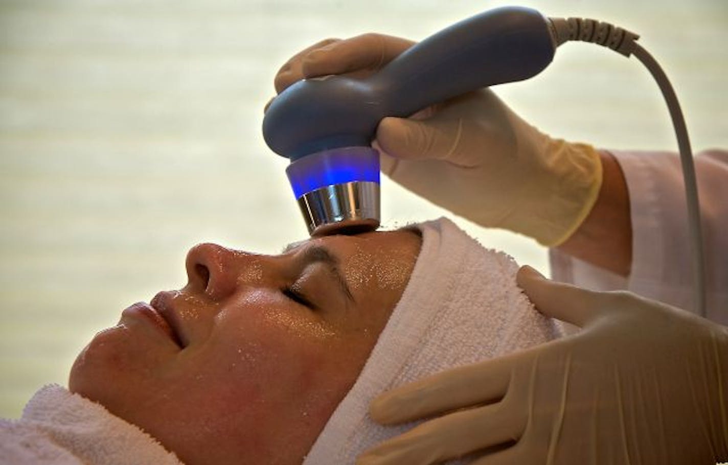 Katie Makousky, spa director at Crutchfield Dermatology, performs a Javani treatment on Alyson Brosseau, an office worker in the practice. Javani gel is infused into the skin using an UltraSonic massage.