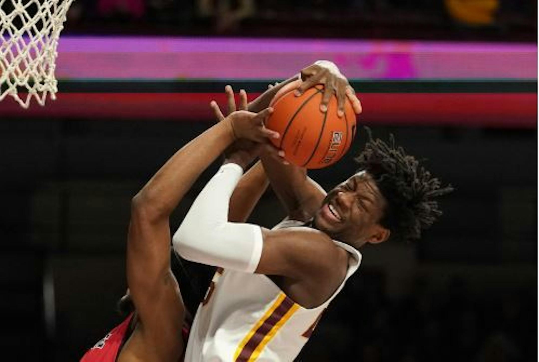 Gophers center Daniel Oturu grabbed a rebound over Arkansas State forward J.J. Matthews earlier this season.