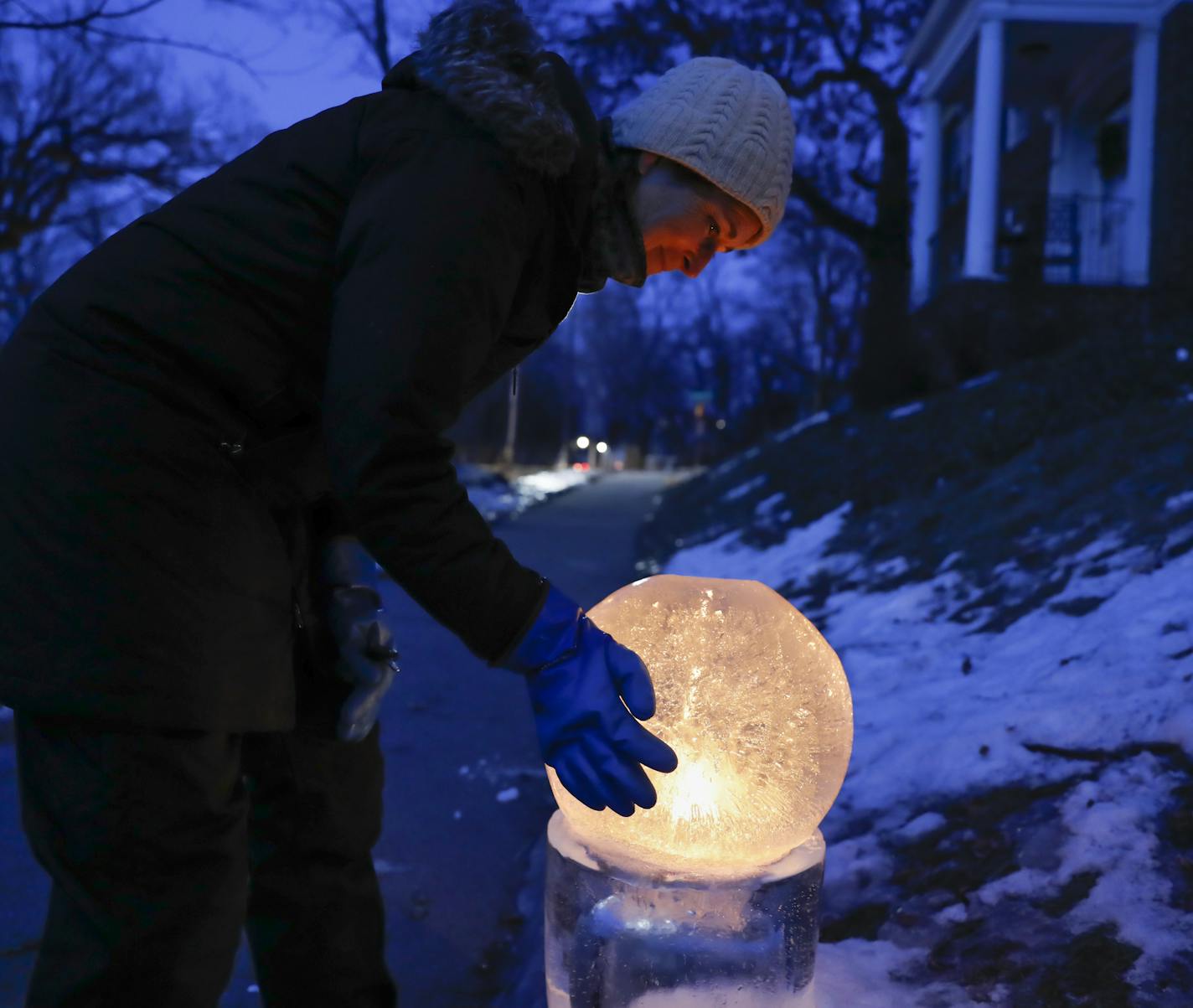 Jennifer Shea Hedberg blew out an ice globe lantern she had installed for a party at a house along Lake of the Isles in Minneapolis.