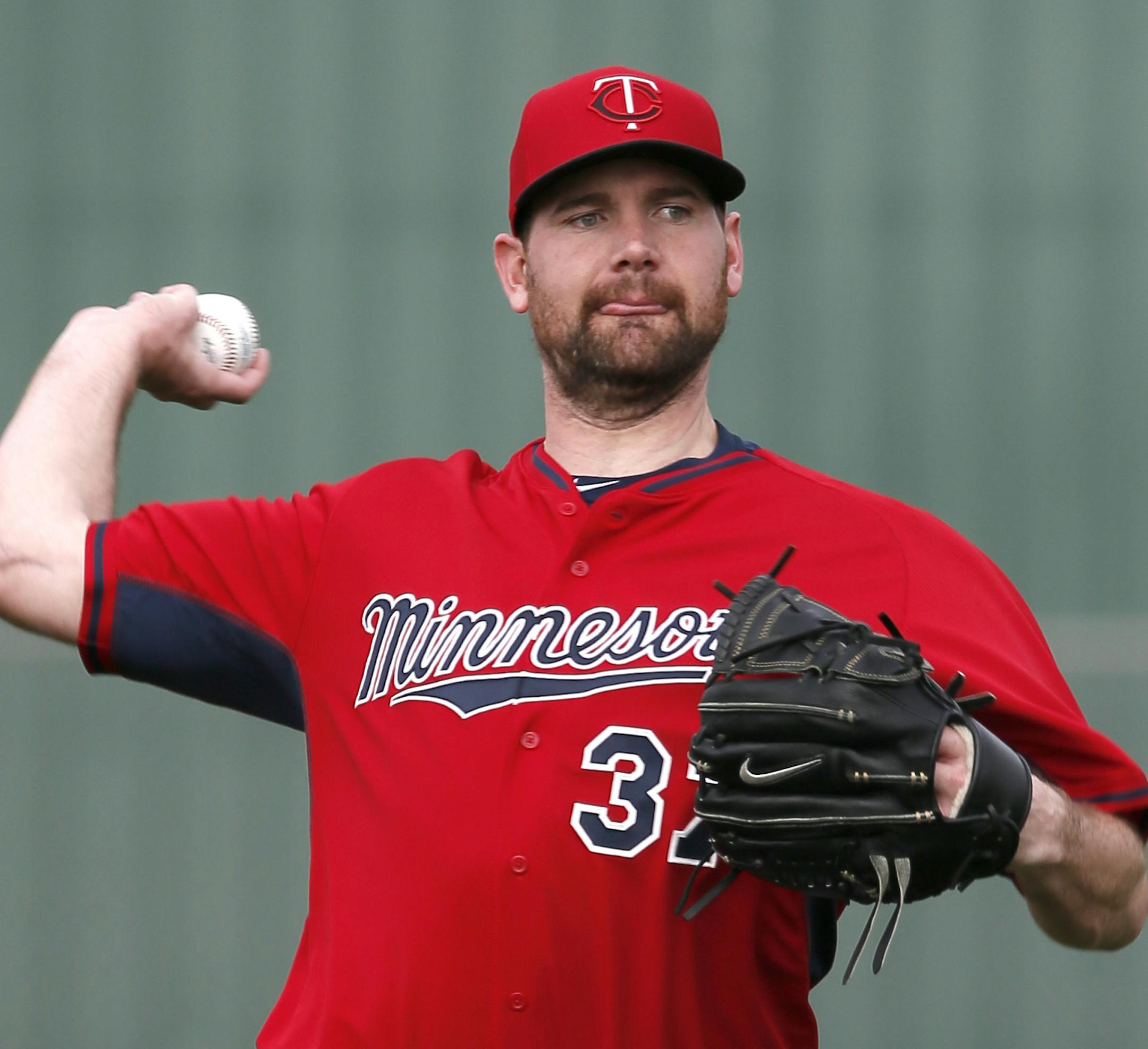 Minnesota Twins' Mike Pelfrey throws as he warms up at the start of a morning workout at baseball spring training in Fort Myers Fla., Tuesday Feb. 24, 2015. (AP Photo/Tony Gutierrez)