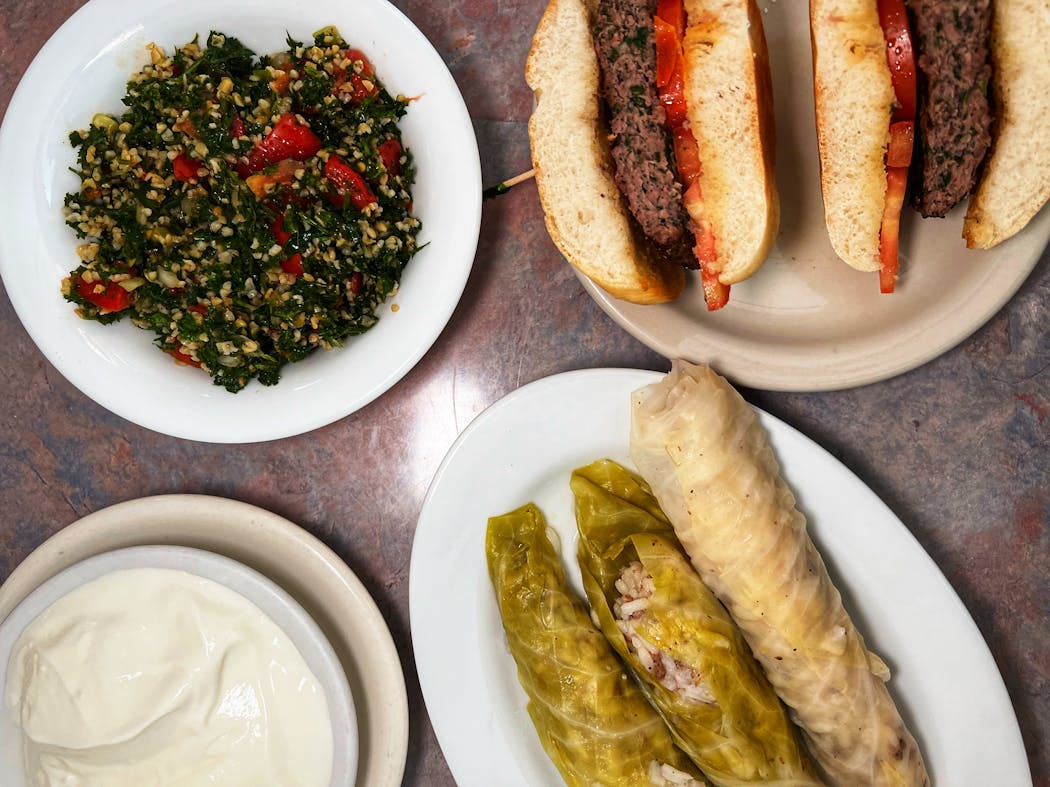 A spread from Emily’s Lebanese Deli includes tabouli, cabbage rolls and the Kafta burger.